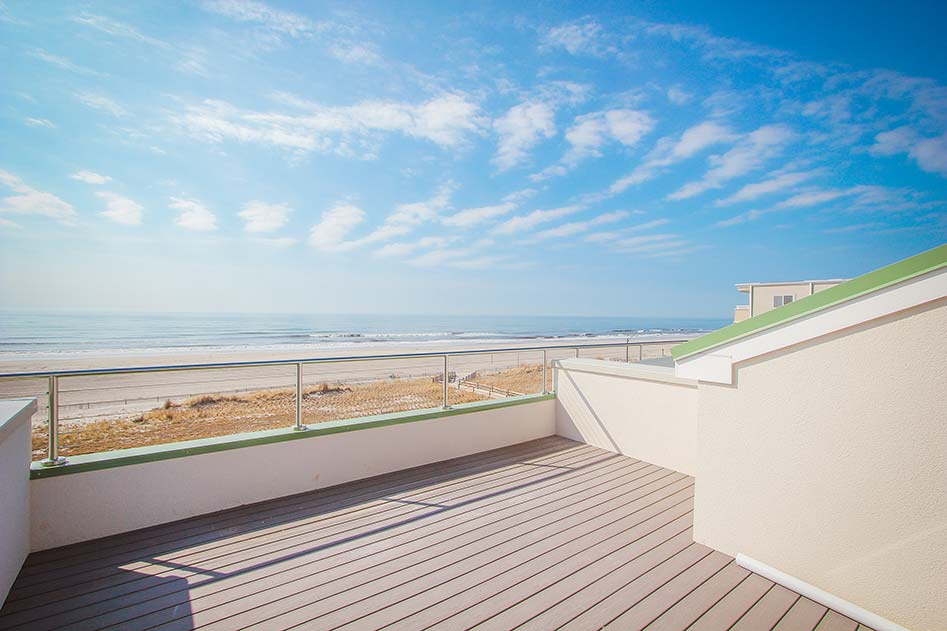 a clean modern rooftop deck overlooking the beach.