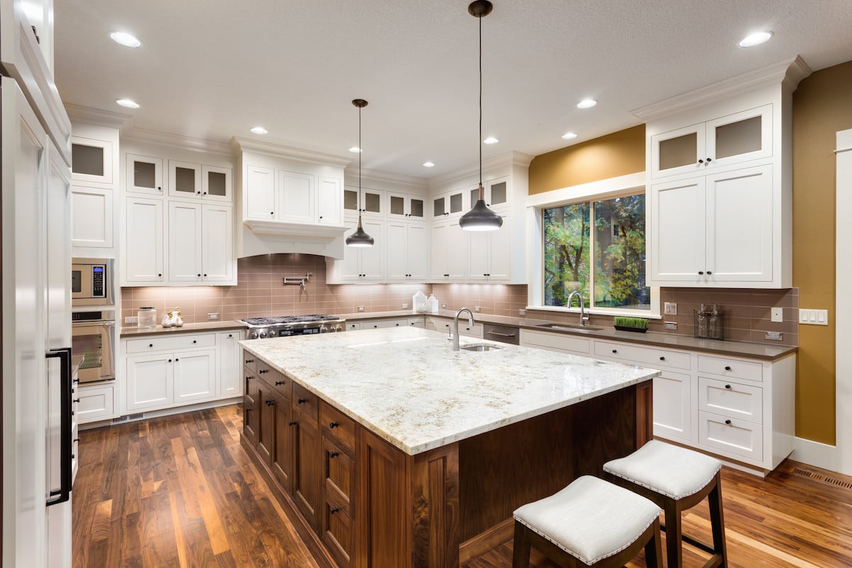 A luxury kitchen with hardwood floors and granite countertops.