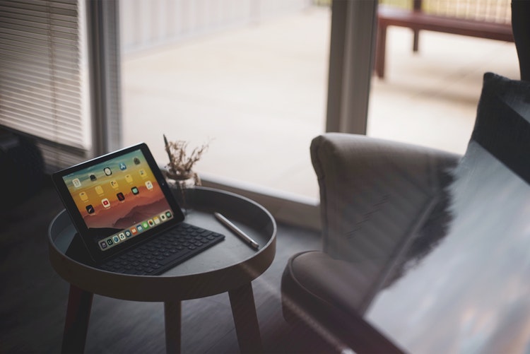 An iPad sitting on a coffee table in a living room.