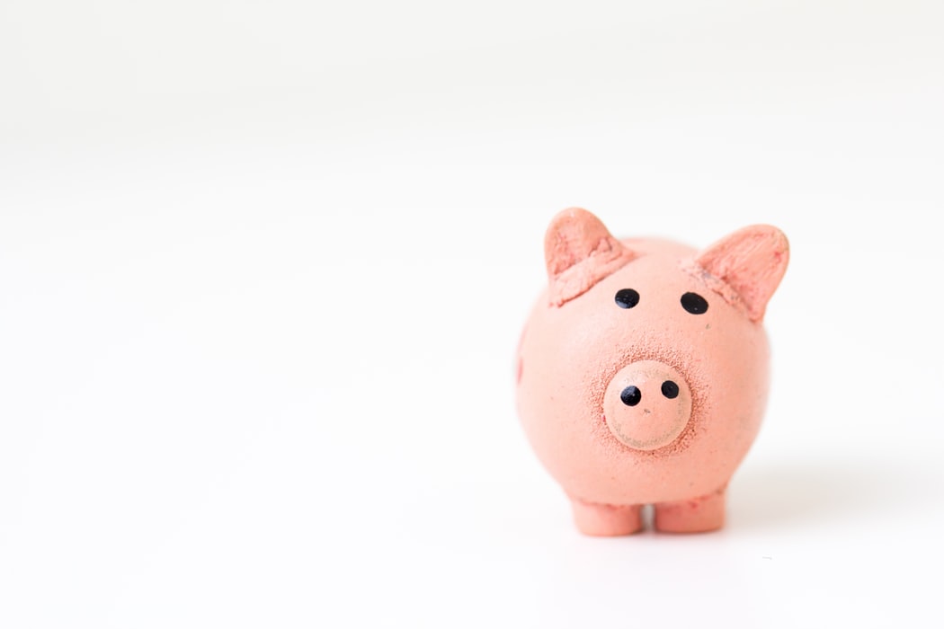 A piggy bank standing against a white background. 